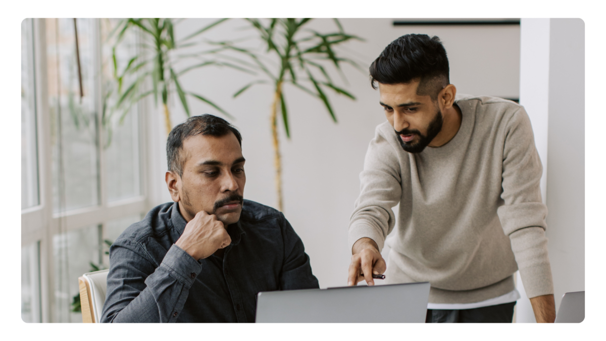 Two men determining reviewing their IT infrastructure on computer