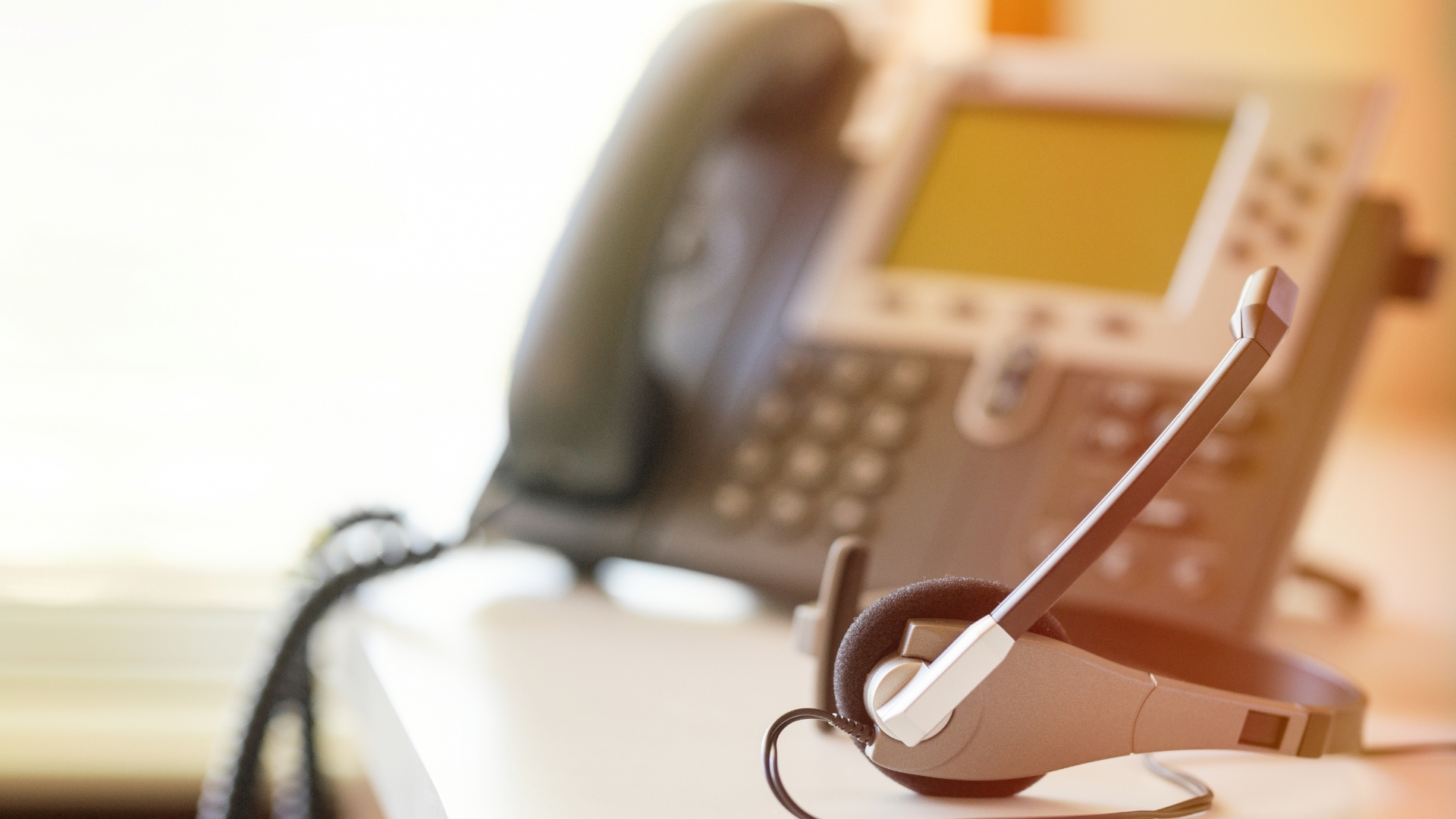 Modern corporate IP desk phone on a clean office desk setup