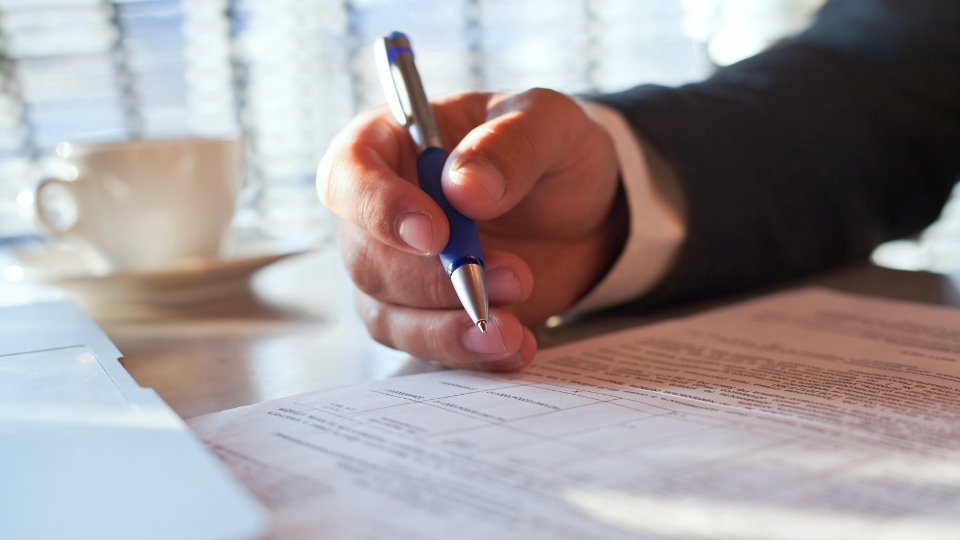 Hand signing a compliance form